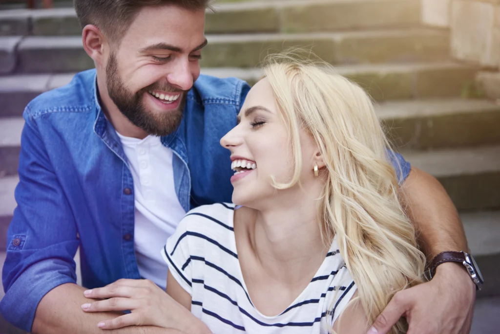 couple laughing loudly steps