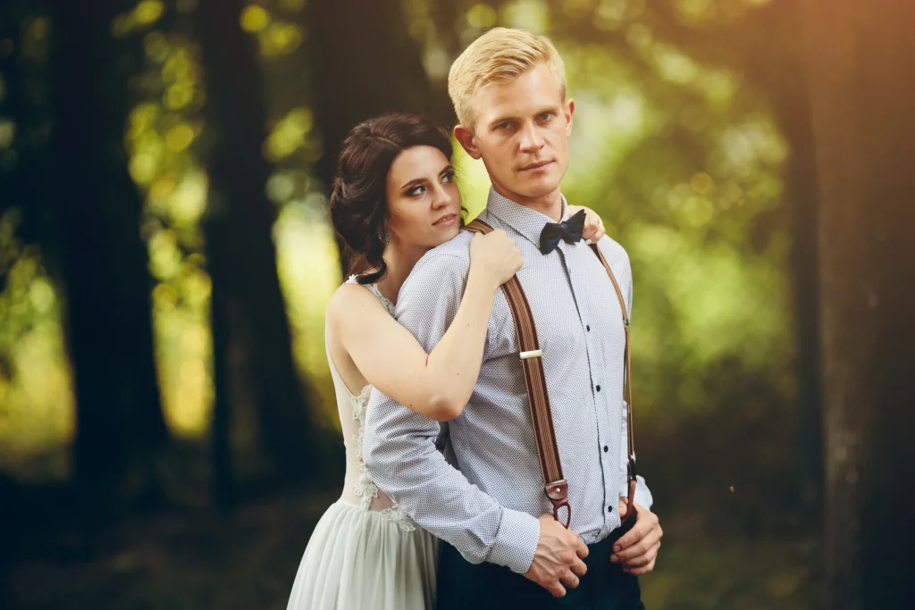 groom gently embraces her groom forest