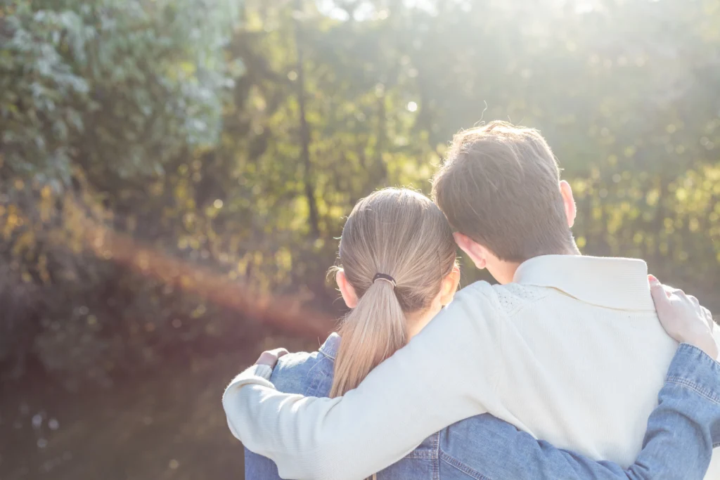 rear view romantic young couple hugging