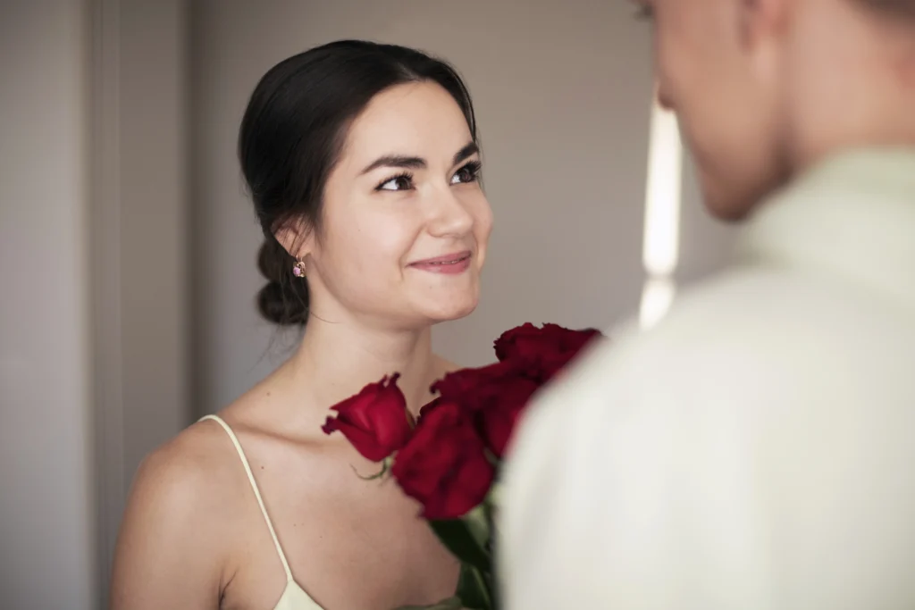 romantic couple celebrating valentines day with bouquet red roses