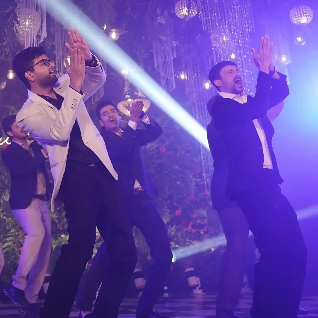 Energetic crowd dancing during a wedding Sangeet night managed by a professional DJ in Kannur