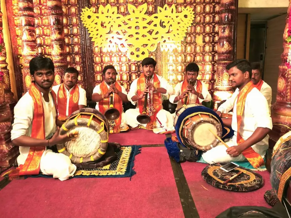 Traditional South Indian Nadaswaram and Thavil musicians performing live on stage at a Kerala wedding event.