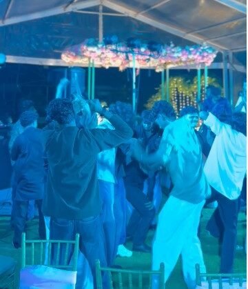 Crowd dancing to DJ music during the evening reception of the intercaste wedding at Ammachi Veedu