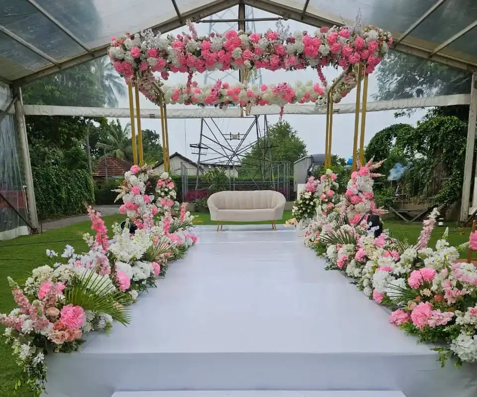 Elegant floral mandap and stage arrangement at Ammachi Veed intercaste wedding