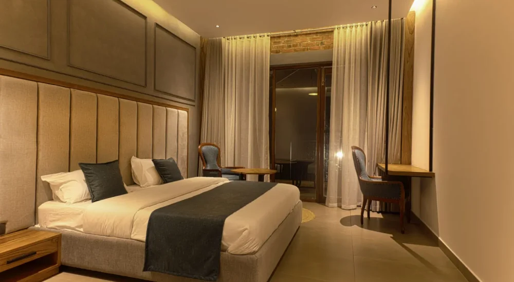Modern upscale guest bedroom with premium amenities and plush bedding at K-Hills Resort and Spa Calicut.