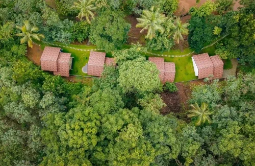 “Aerial view of Ambient Xperience Kodakkara Thrissur luxury wedding venue with lush greenery and open lawns
