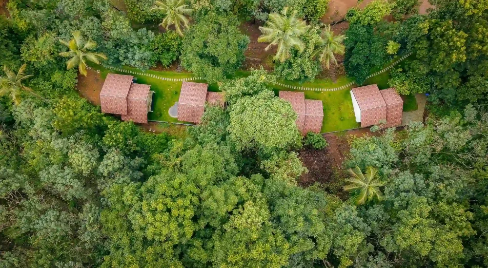 “Aerial view of Ambient Xperience Kodakkara Thrissur luxury wedding venue with lush greenery and open lawns