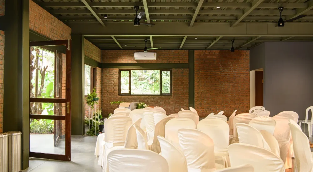 Ammachi Veedu heritage wedding venue in Kanjikuzhi Kottayam showing traditional Kerala wooden interior hall with intricate timber architecture.