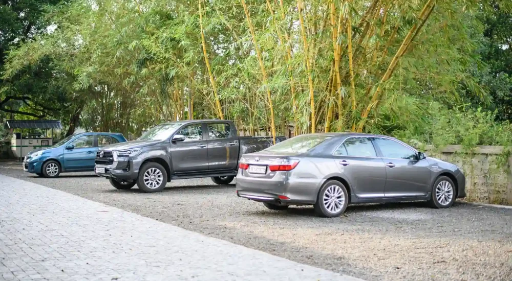 Ammachi Veedu heritage wedding venue in Kanjikuzhi Kottayam showing guest parking area and paved approach road.