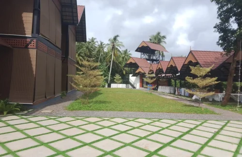 Arcadia Resort & Banquet ,Paved courtyard with vertical green wall at Arcadia Resort.