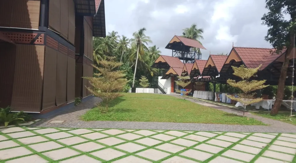 Arcadia Resort & Banquet ,Paved courtyard with vertical green wall at Arcadia Resort.