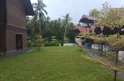 Arcadia Resort & Banquet ,Paved entrance courtyard and main villa at Arcadia Resort Guruvayoor.