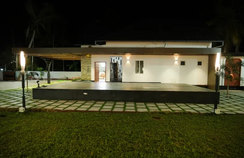 Night view of the built-in stage and semi-indoor building at Coconut Groves event venue in Kanjiramattom.