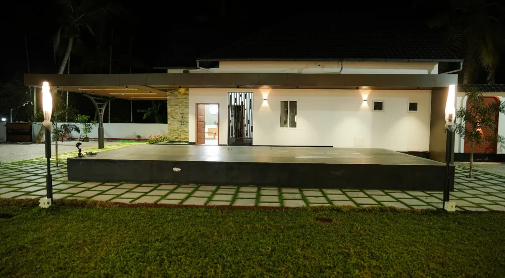 Night view of the built-in stage and semi-indoor building at Coconut Groves event venue in Kanjiramattom.