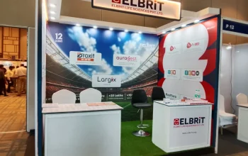 Corporate event setup managed by Melodia Event Management in Trivandrum, featuring custom Melbrit display banners, branded counter stands, and a modern stage setup