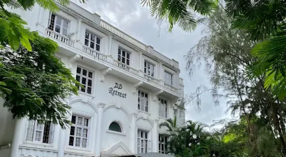 DD Retreat in Ernakulam is a spacious and well-equipped event venue ideal for grand celebrations, including weddings, receptions, and corporate functions. With a total guest capacity of up to 1,000, the venue offers both indoor and outdoor spaces to suit diverse event preferences. The indoor hall, priced at ₹1,10,000, provides a comfortable and elegant setting, while the outdoor area, available at ₹70,000, is perfect for open-air functions under the sky. The property also features ample parking space for up to 400 vehicles, ensuring hassle-free convenience for guests.