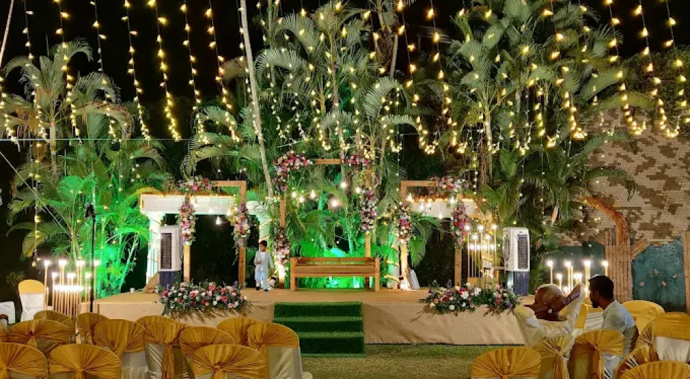 DD Retreat in Ernakulam is a spacious and well-equipped event venue ideal for grand celebrations, including weddings, receptions, and corporate functions. With a total guest capacity of up to 1,000, the venue offers both indoor and outdoor spaces to suit diverse event preferences. The indoor hall, priced at ₹1,10,000, provides a comfortable and elegant setting, while the outdoor area, available at ₹70,000, is perfect for open-air functions under the sky. The property also features ample parking space for up to 400 vehicles, ensuring hassle-free convenience for guests.