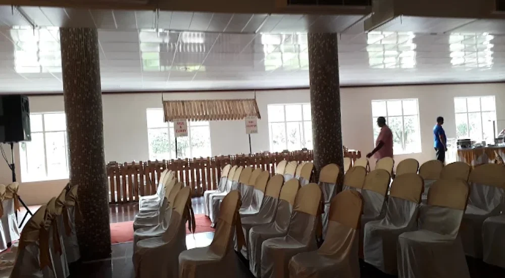 DD Retreat in Ernakulam is a spacious and well-equipped event venue ideal for grand celebrations, including weddings, receptions, and corporate functions. With a total guest capacity of up to 1,000, the venue offers both indoor and outdoor spaces to suit diverse event preferences. The indoor hall, priced at ₹1,10,000, provides a comfortable and elegant setting, while the outdoor area, available at ₹70,000, is perfect for open-air functions under the sky. The property also features ample parking space for up to 400 vehicles, ensuring hassle-free convenience for guests.