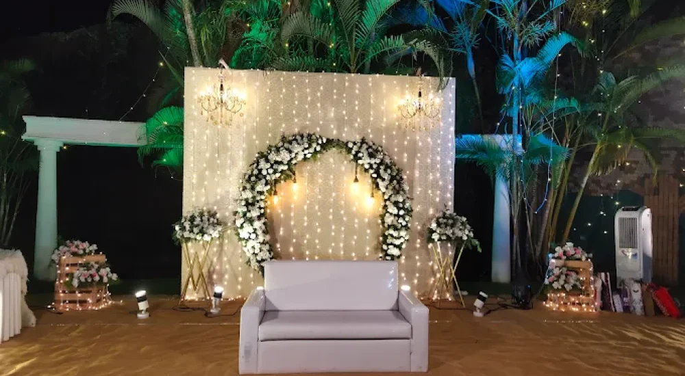 DD Retreat in Ernakulam is a spacious and well-equipped event venue ideal for grand celebrations, including weddings, receptions, and corporate functions. With a total guest capacity of up to 1,000, the venue offers both indoor and outdoor spaces to suit diverse event preferences. The indoor hall, priced at ₹1,10,000, provides a comfortable and elegant setting, while the outdoor area, available at ₹70,000, is perfect for open-air functions under the sky. The property also features ample parking space for up to 400 vehicles, ensuring hassle-free convenience for guests.