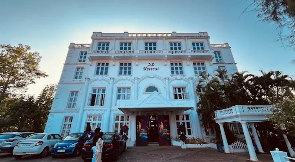 DD Retreat in Ernakulam is a spacious and well-equipped event venue ideal for grand celebrations, including weddings, receptions, and corporate functions. With a total guest capacity of up to 1,000, the venue offers both indoor and outdoor spaces to suit diverse event preferences. The indoor hall, priced at ₹1,10,000, provides a comfortable and elegant setting, while the outdoor area, available at ₹70,000, is perfect for open-air functions under the sky. The property also features ample parking space for up to 400 vehicles, ensuring hassle-free convenience for guests.