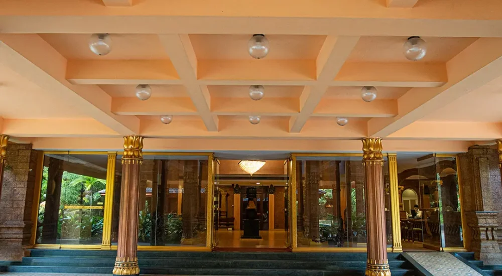 Grand traditional entrance of Krishna Beach Resort Kannur featuring classic Kerala architectural design.