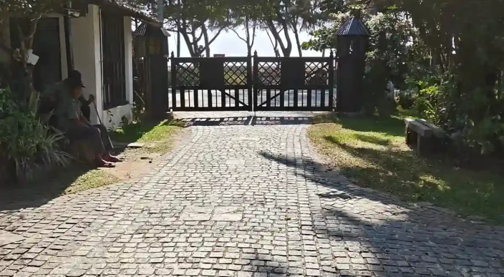 Traditional Kerala-style arched wooden corridor and resort walkway at Indriya Sands destination wedding resort near Kuzhupilly Beach, Kochi.
