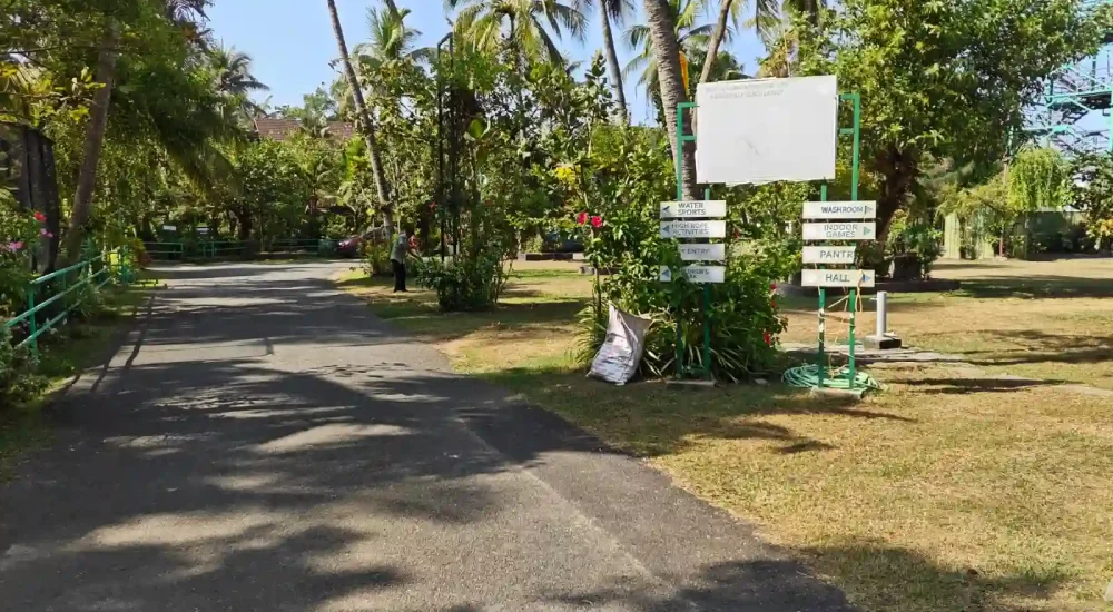 Tree-lined entrance driveway and lush resort grounds at Indriya Sands destination wedding resort near Kuzhupilly Beach, Kochi.