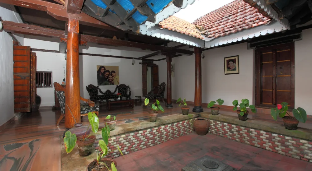 Classic Ettukettu style interiors with open courtyard and handcrafted wooden ceilings