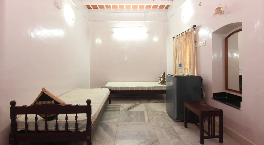 Traditional Kerala heritage suite with large wooden windows and peaceful countryside views