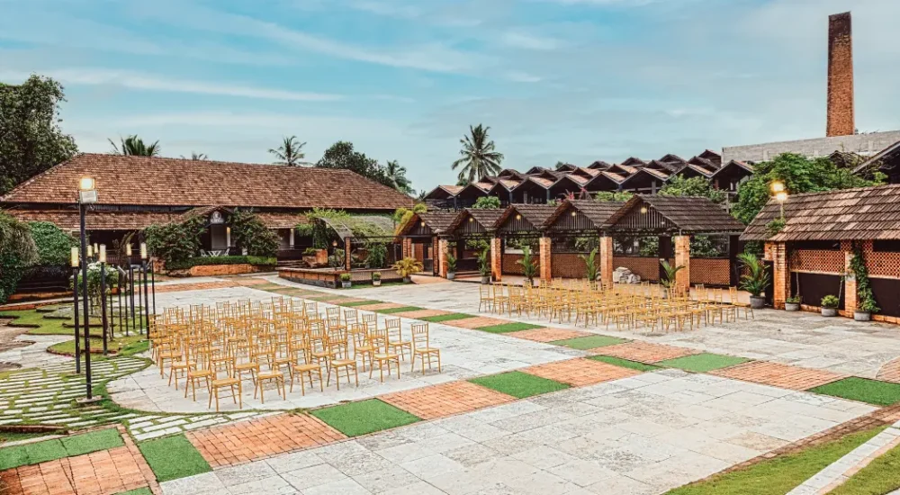 Premium open-air destination wedding stage setup on the Tera garden lawn at K-Hills Resort Kerala.
