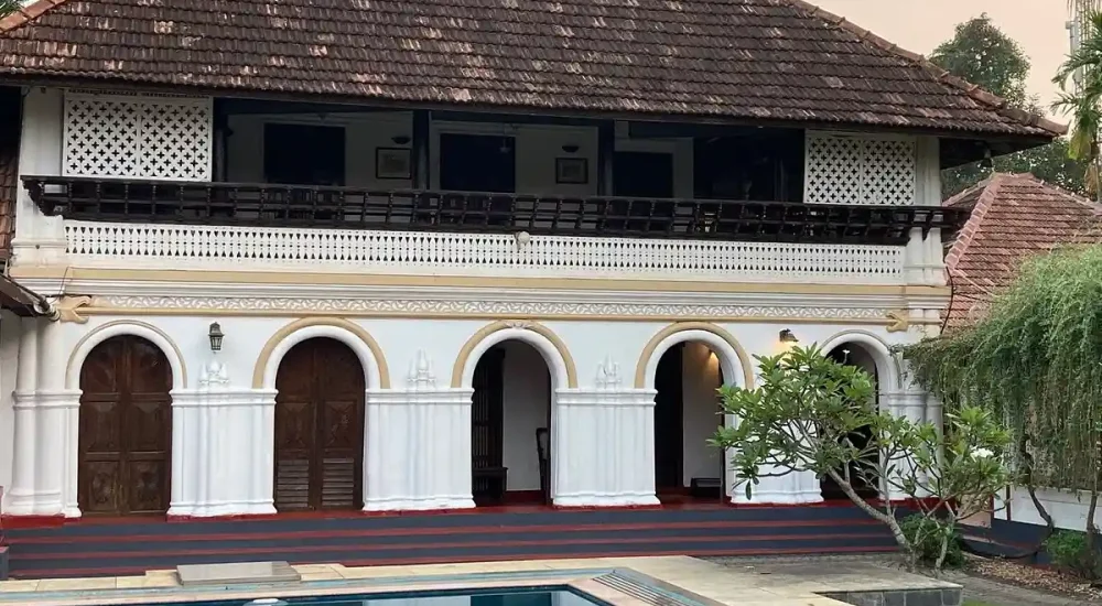 Swimming pool and traditional Kerala tharavadu architecture at Kumarakom Tharavadu heritage hotel