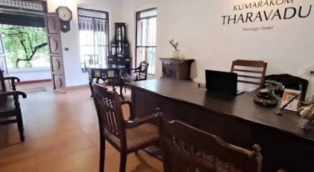 Heritage hotel reception area featuring traditional Kerala wood architecture at Kumarakom Tharavadu