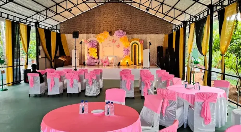 Interior view of the structured semi-open hall at Mankara Farms, Puthenchira, featuring a beautifully decorated wedding stage with elegant draping and custom floral installations.