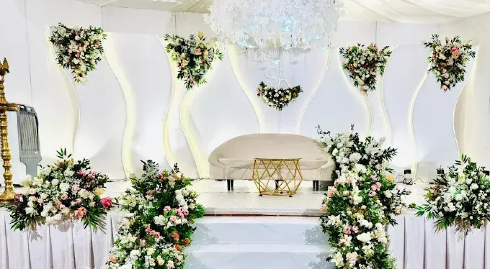 Elegant wedding stage decoration by Melodia Event Management inside the centralized AC auditorium of Namas International Convention Centre.