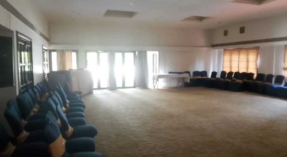 Periyar Banquet Hall interior with banquet chairs and glass doors for indoor wedding functions at Rhythm Kumarakom