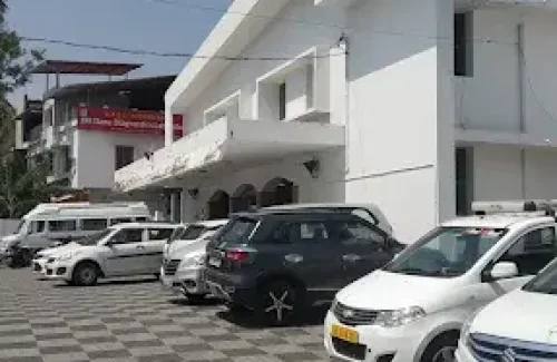 Exterior view of Shadi Mahal on Court Road, Palakkad, showing the entrance and the dedicated parking area for cars.