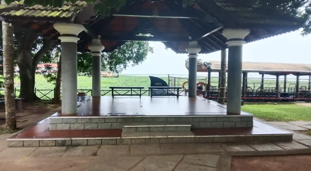 Close-up view of the traditional Kerala-style open-air mandapam pavilion with tiled roofing and pillars overlooking the backwaters at Backwater Ripples Hotel Kumarakom.