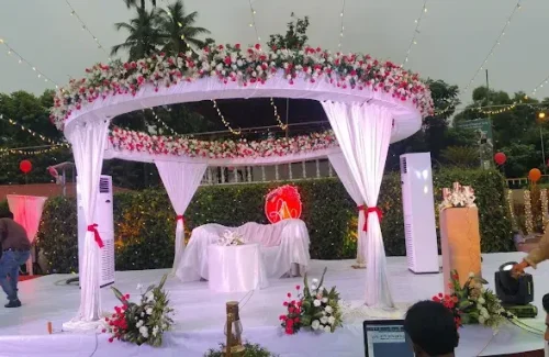 Modern wedding reception stage decoration with geometric frames and pampas grass on the lawn at Hotel Merlin International by melodia event management.