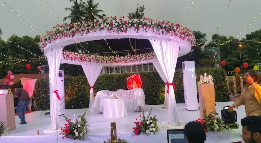 Modern wedding reception stage decoration with geometric frames and pampas grass on the lawn at Hotel Merlin International by melodia event management.
